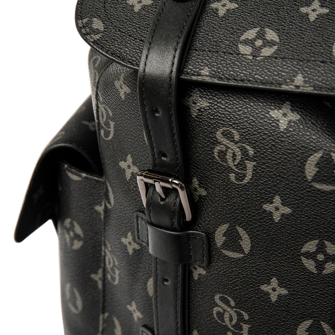 Black leather bag with a monogram pattern on a white background
