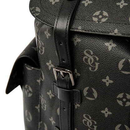 Black leather bag with a monogram pattern on a white background