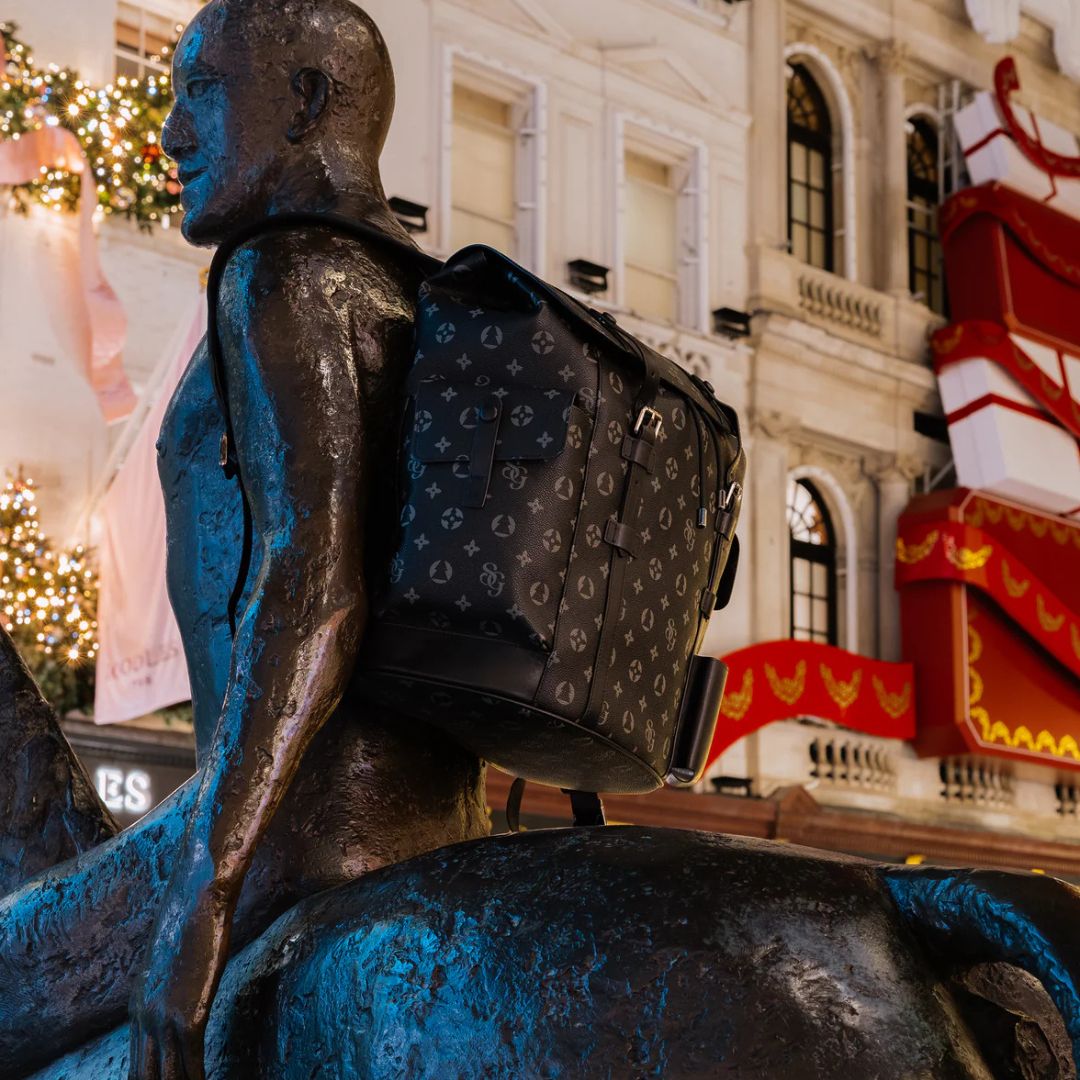Mannequin with a patterned backpack against a city street background