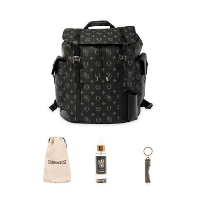 Black patterned backpack with a small bag, bottle, and keychain on a white background