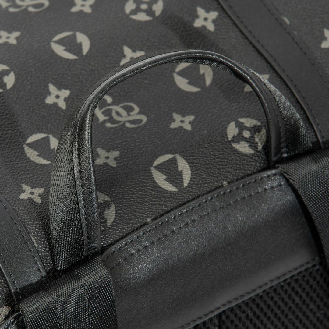 Close-up of a black bag with a patterned design on a dark background
