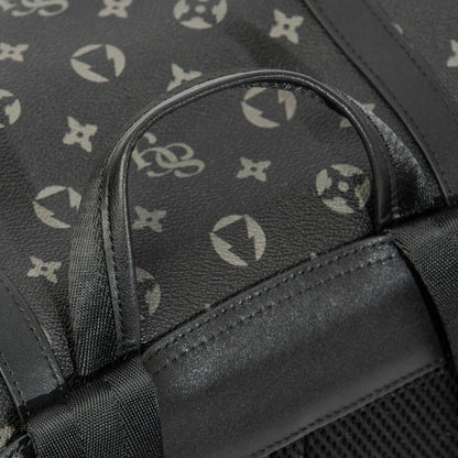 Close-up of a black bag with a patterned design on a dark background