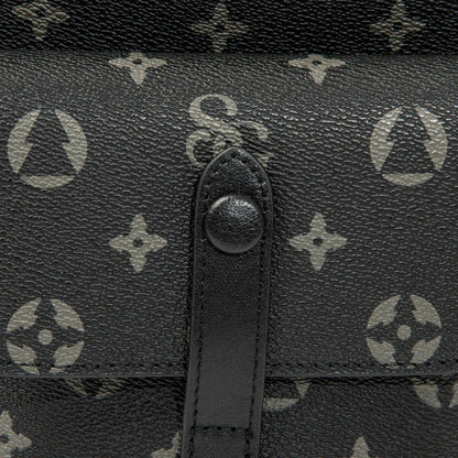 Close-up of a black leather handbag with a brand logo pattern