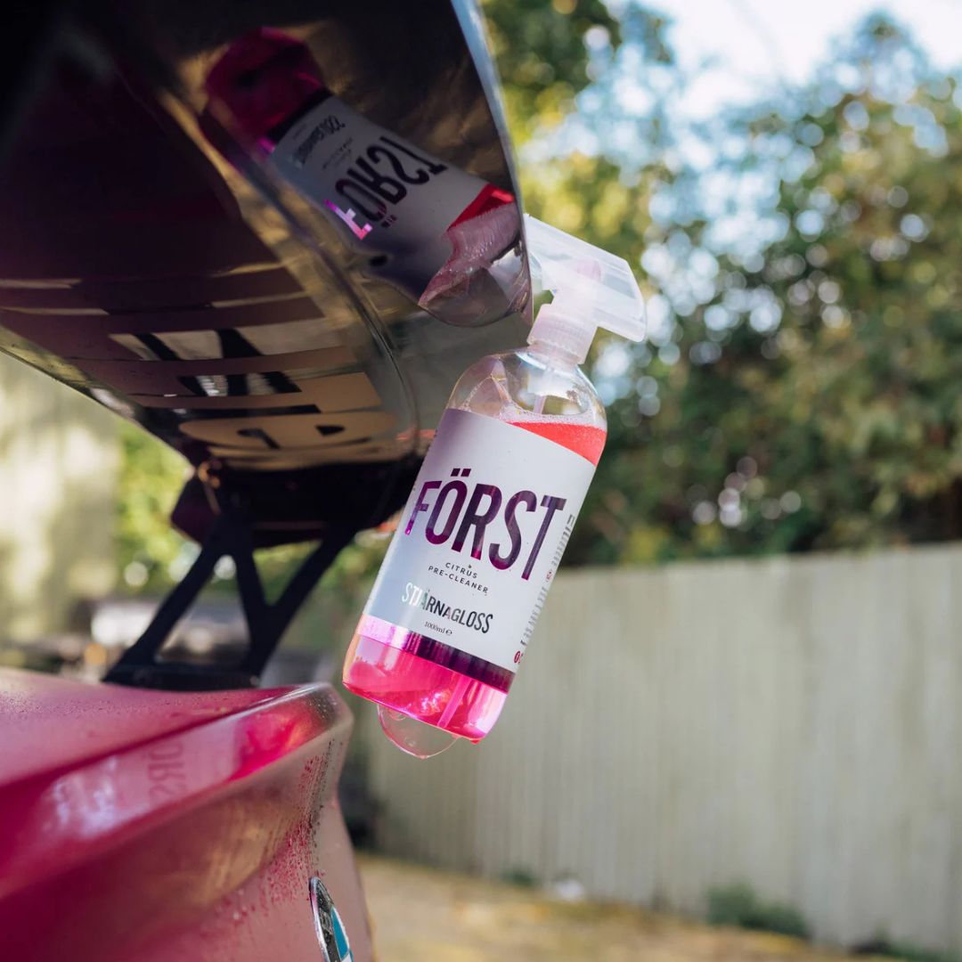 Stjarnagloss Först car care product being sprayed onto a car's rear spoiler.