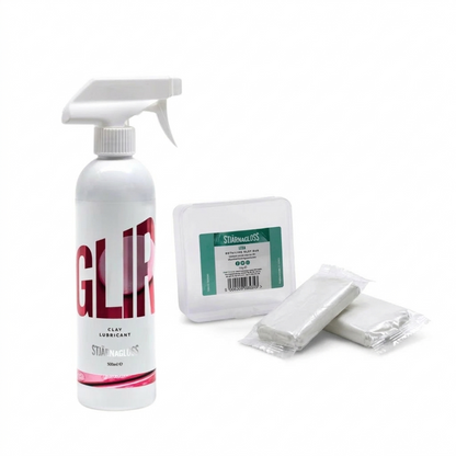 White spray bottle labeled Stjarnagloss Glir with two clay bars on a white background