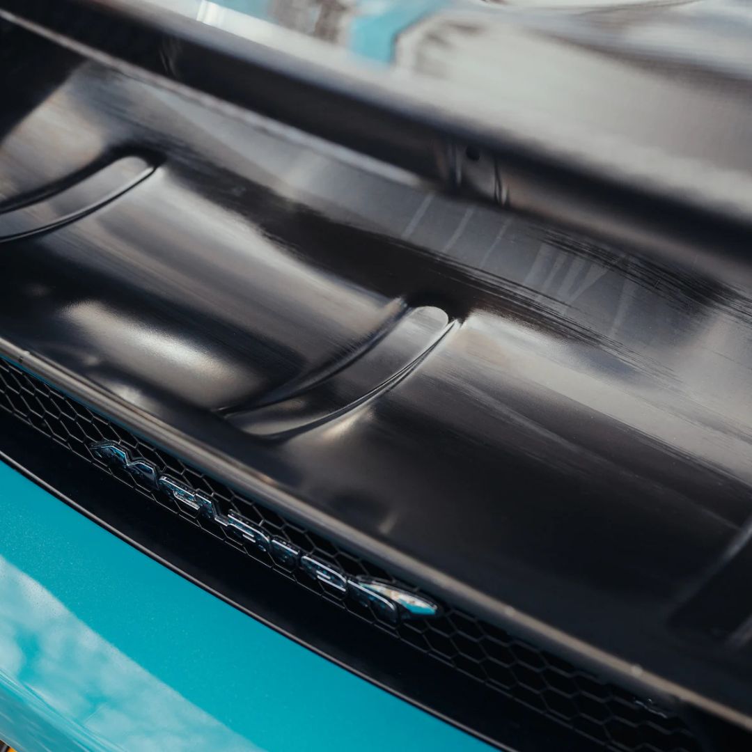 Close-up of a car's front grille with a visible brand logo from McLaren