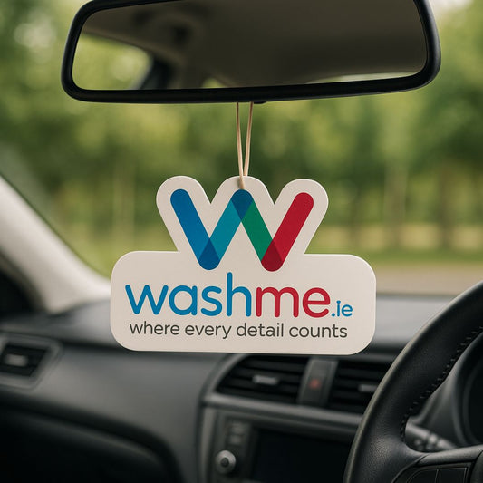 Car air freshener with 'washme.ie' logo hanging from a car's rearview mirror.