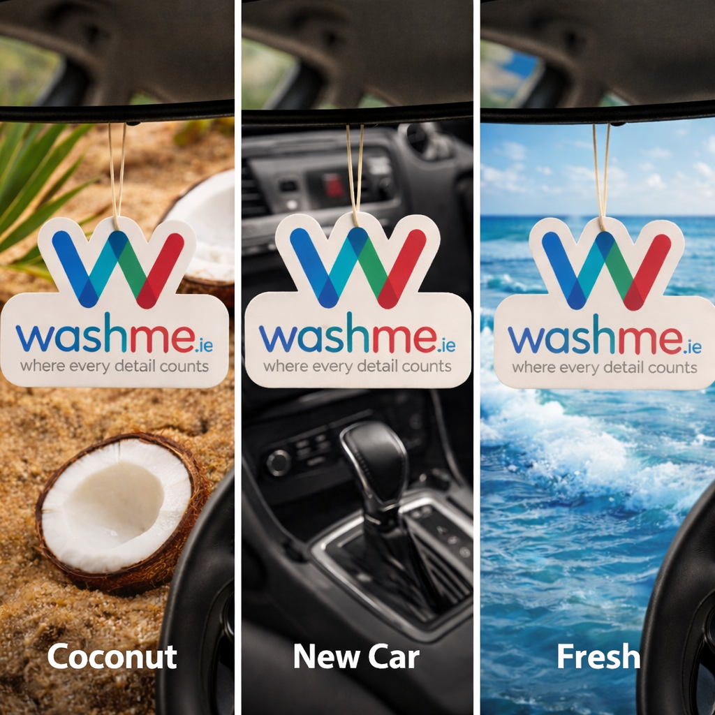Three 'washme.ie' air freshener tags with different scents in a car interior. Coconut air freshener, new car air freshener, ocean fresh air freshener.
