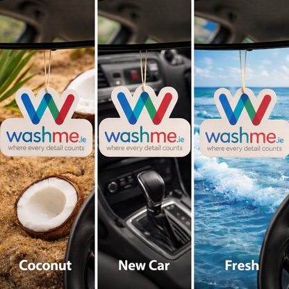 Three 'washme.ie' air freshener tags with different scents in a car interior. Coconut air freshener, new car air freshener, ocean fresh air freshener.
