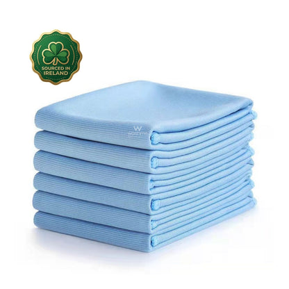 Stack of blue glass cloths with a 'Sourced in Ireland' logo on a white background