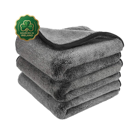 Stack of grey polishing cloth and towel with 600gsm weight towels with a shamrock logo indicating 'Sourced in Ireland' on a white background.