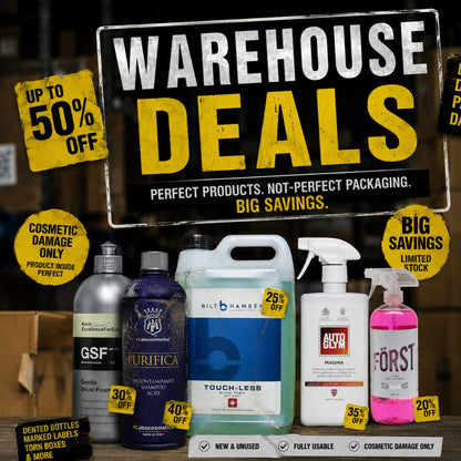Warehouse deals sign with various cleaning products and discount labels in a warehouse setting.