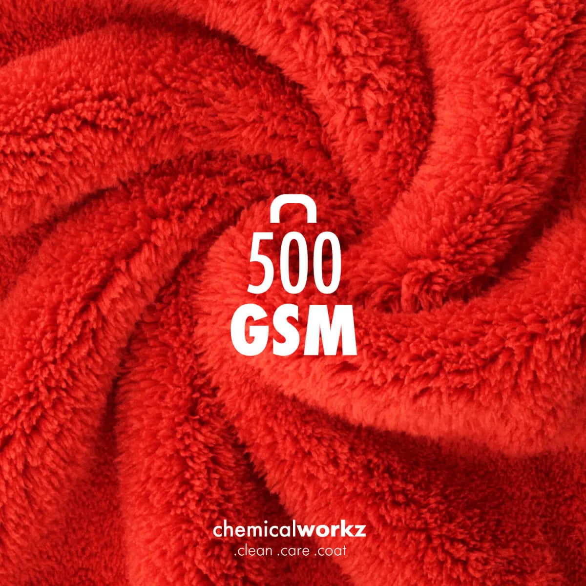 A close-up of bright red plush microfibre with a visible texture, arranged in a swirl pattern. White text in the center reads '500 GSM', and near the bottom reads 'chemicalworkz clean care coat'.