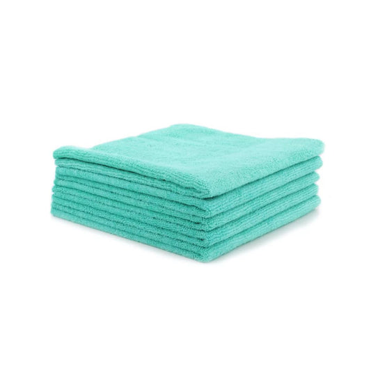 Stack of teal microfiber cloths on a white background
