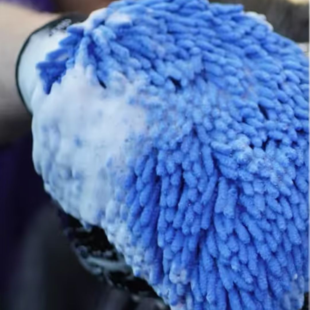 Blue microfiber cleaning glove with a blurred background
