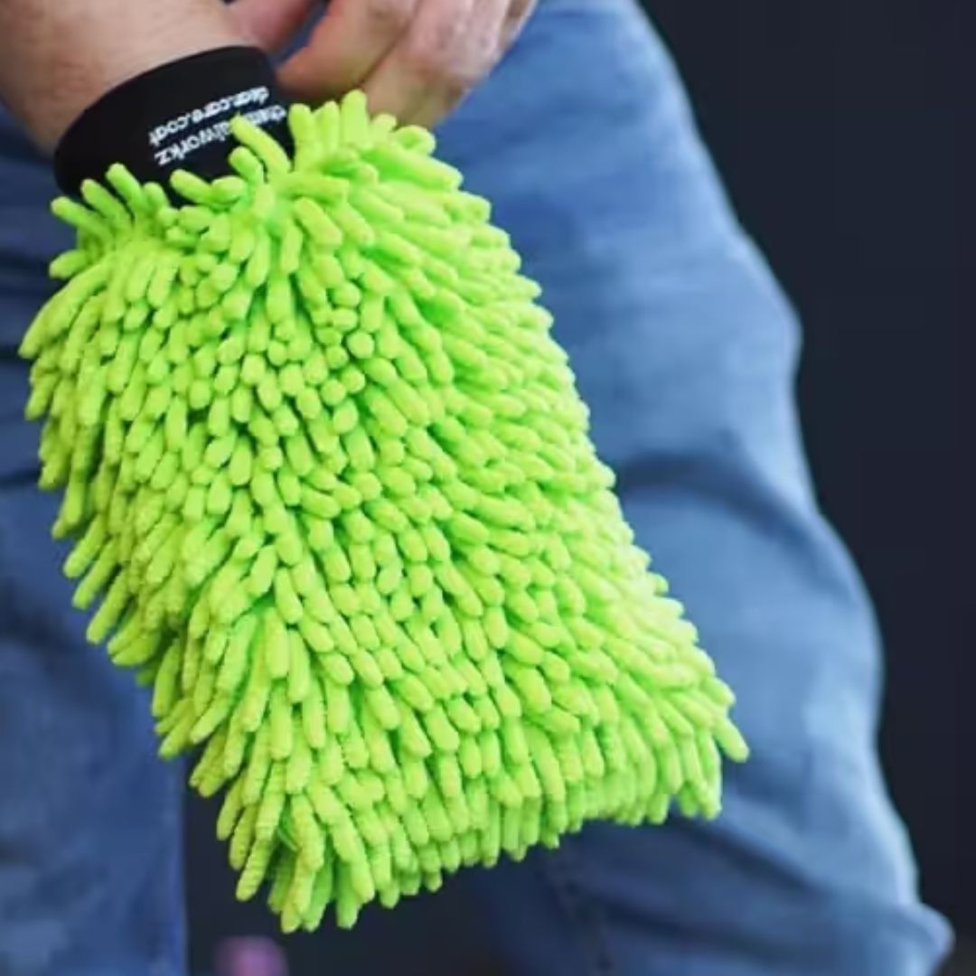 Green chemicalworkz microfiber cleaning glove held by a person wearing a blue jacket.