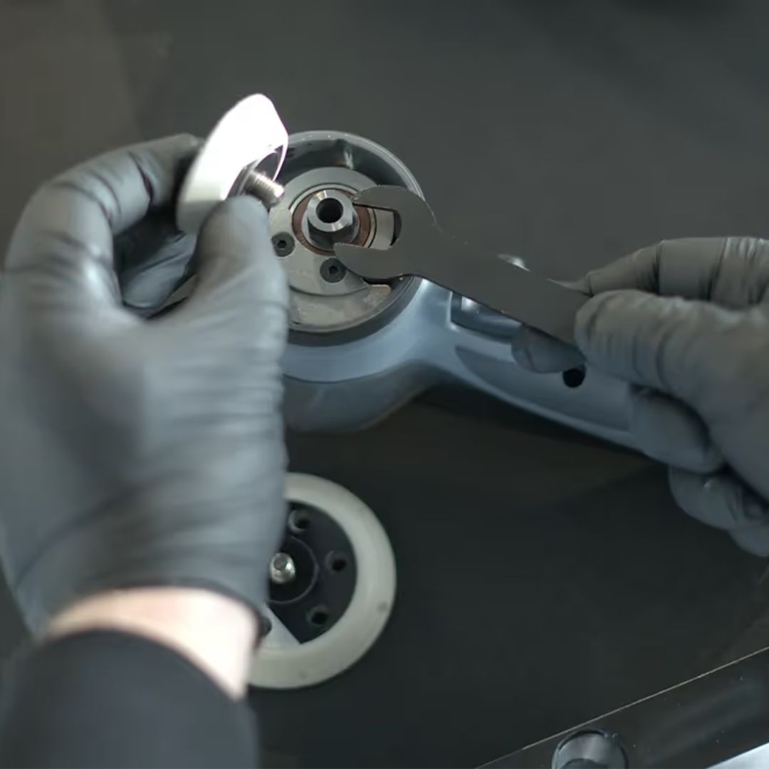 Person wearing gloves using a tool on a chemicalworkx polishing machine