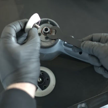 Person wearing gloves using a tool on a chemicalworkx polishing machine