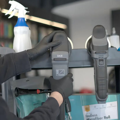 Person using a chemicalworkz DA15 with a spray bottle and cleaning equipment in the background