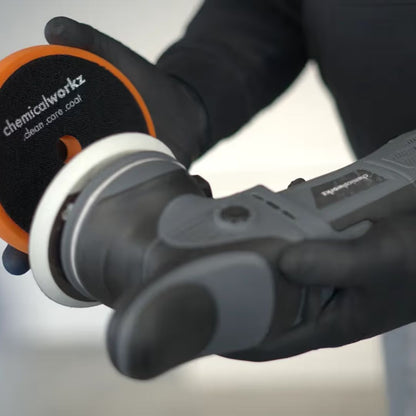 Person holding a polisher with a 'chemicalworkz' pad on a white background