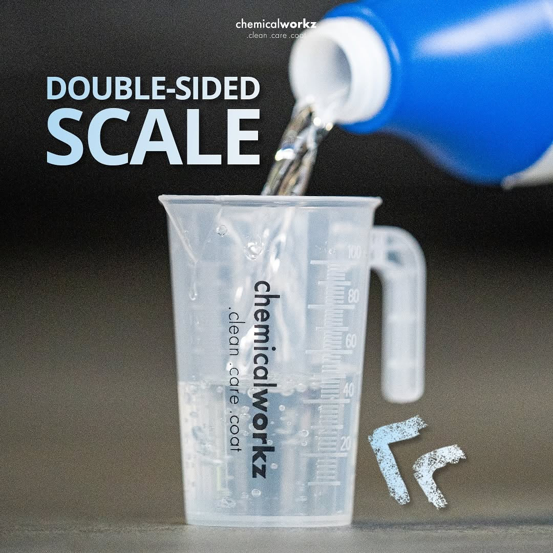 Double-sided scale being used with a blue container and clear measuring cup on a dark background.
