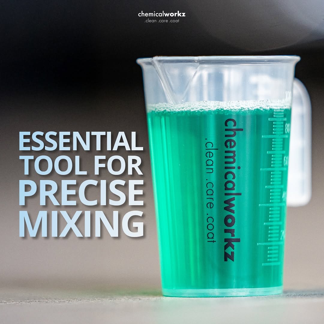 Measuring cup with blue liquid and 'chemicalworkz' branding on a dark background