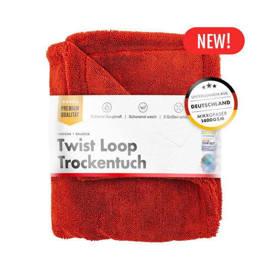 Red towel with packaging labeled 'Twist Loop Trockentuch' on a white background