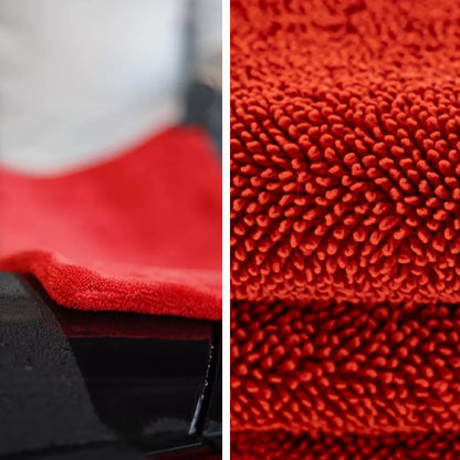 Red microfiber drying towel with close-up texture details on a black background