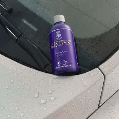 Blue Labocosmetica REVITAX Wash and Coat Shampoo bottle on white bonnet showing sheeting of water. Labocosmetica Ireland